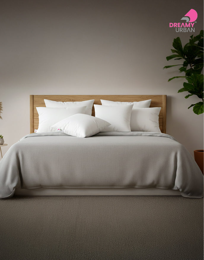 White cushion pads inner arranged on a modern wooden bed